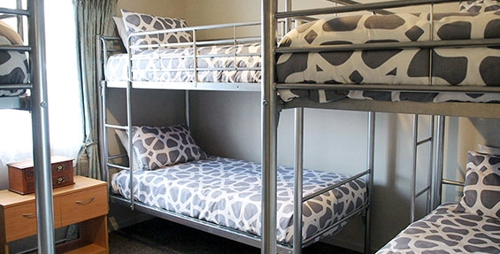 three sets of single bunks in second room of three-bedroom unit